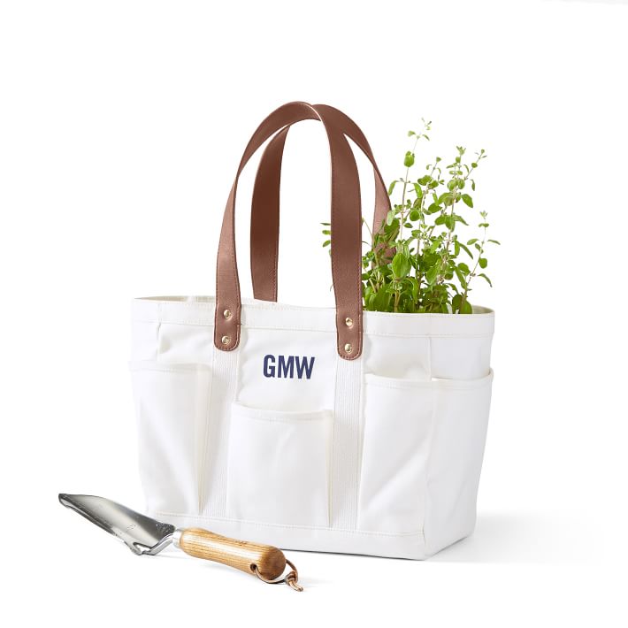 A handcrafted garden tote bag made from lightweight but durable cotton canvas material with features eight handy outer pockets for gardening tools, gloves, etc is the best Christmas gift for women those who love do gardening