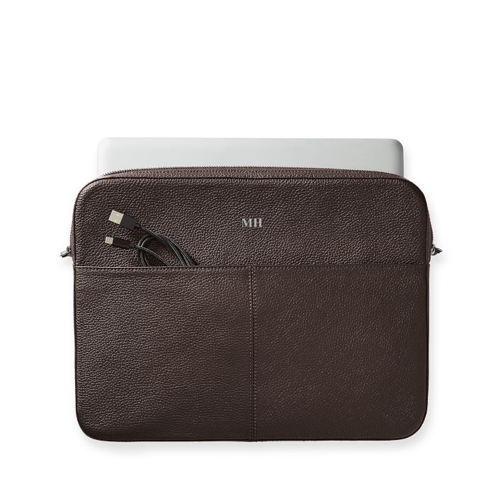 a classic style solid color laptop case made from high-quality leather with a soft cotton lining, a zipper closure, and an outside slip pocket