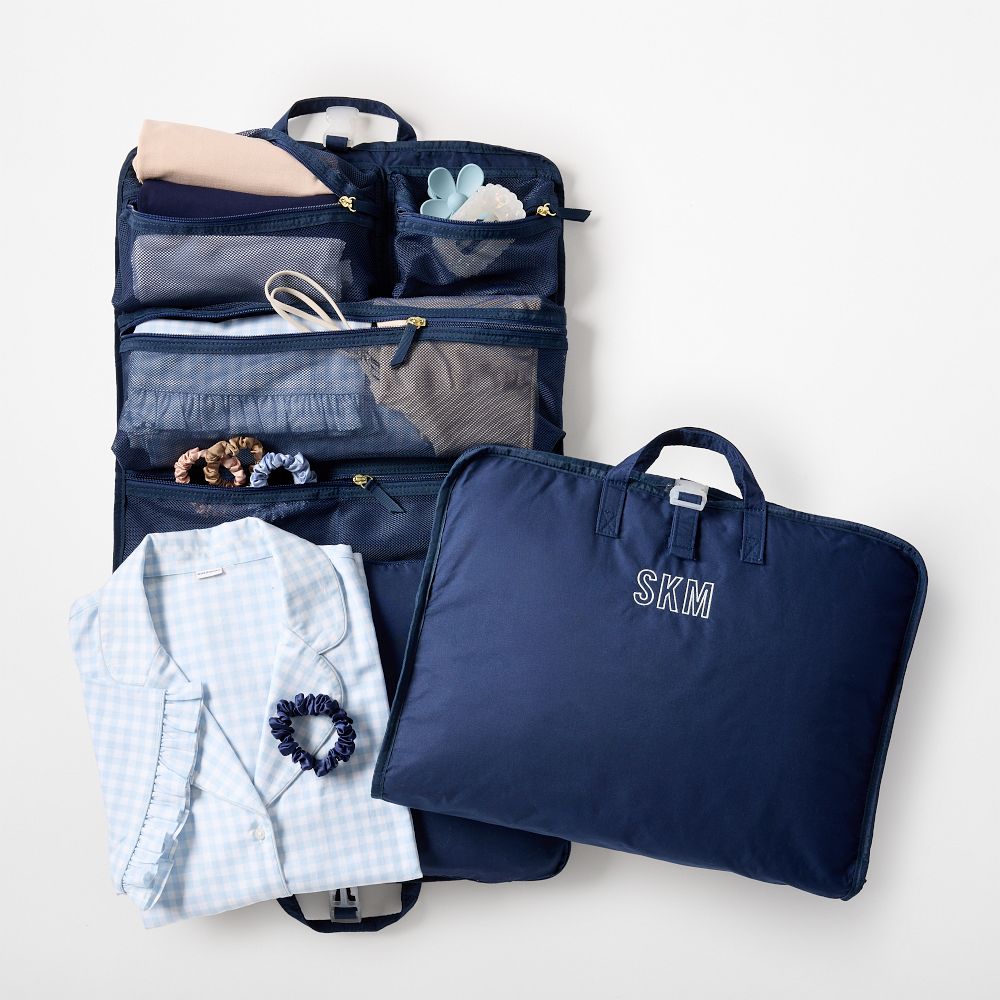 Navy Mark and Graham Travel Roll Up Clothing Organizer opened to show packed shirts and accessories
